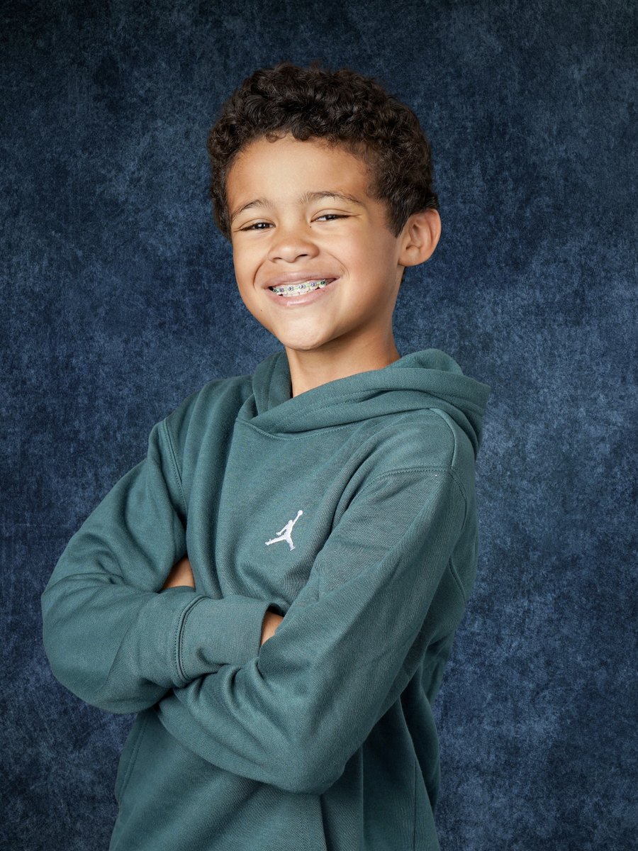 Bryson smiling with his arms crossed